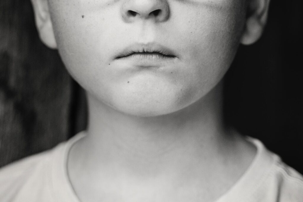 close up photo of boy s mouth